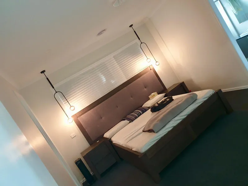 Bedroom with pendant lights hanging either side of the bed