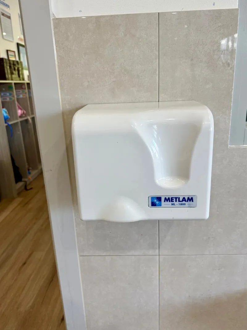 Metlam electric hand dryer installed on a tiled wall