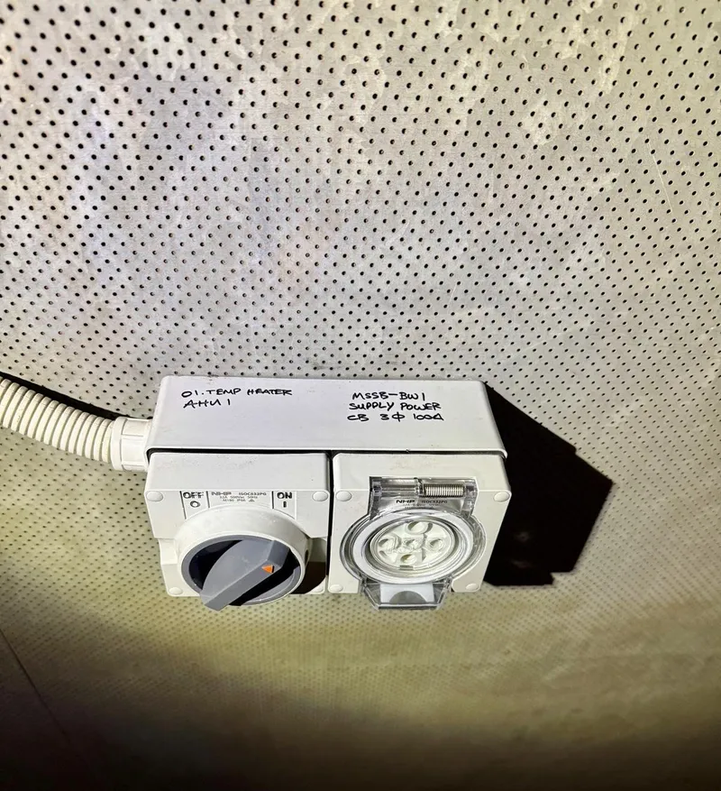 Industrial isolator switch and three-phase power point with handwritten circuit labels