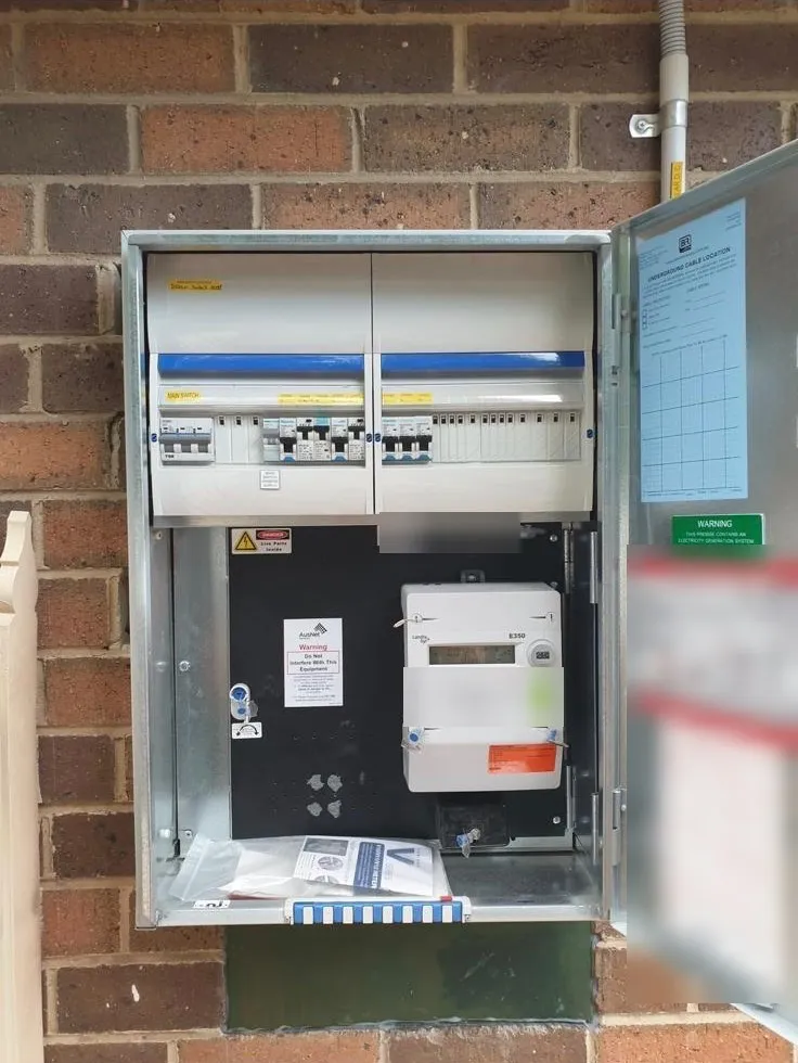 After: a new galvanised meter box with a two-section switchboard, main switch and circuit breakers, and the meter below