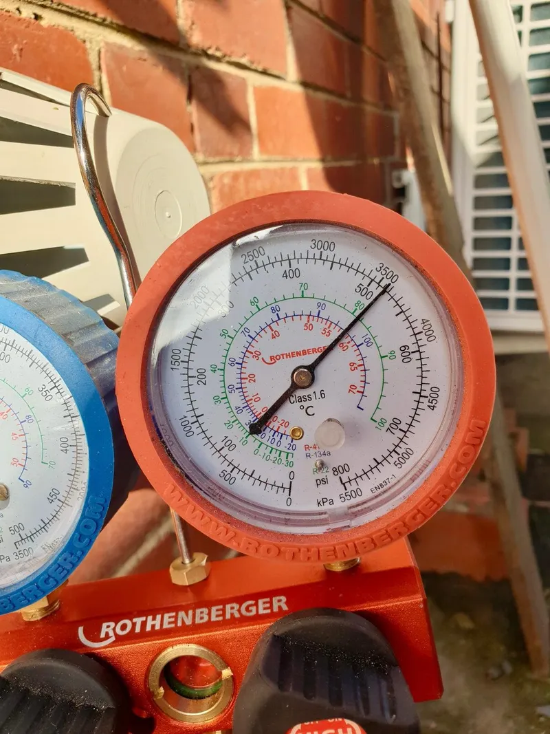Refrigerant pressure gauge on a manifold set during an air conditioning job