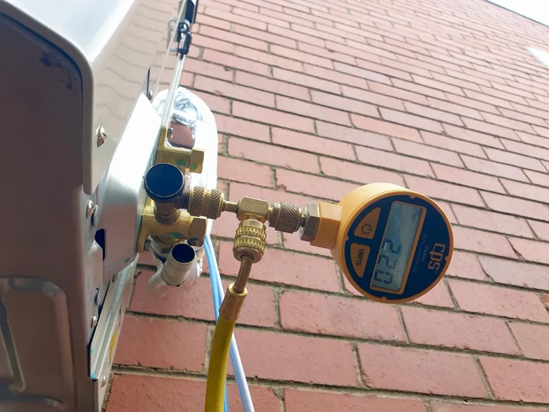 Digital vacuum gauge connected to the service valve of an outdoor unit