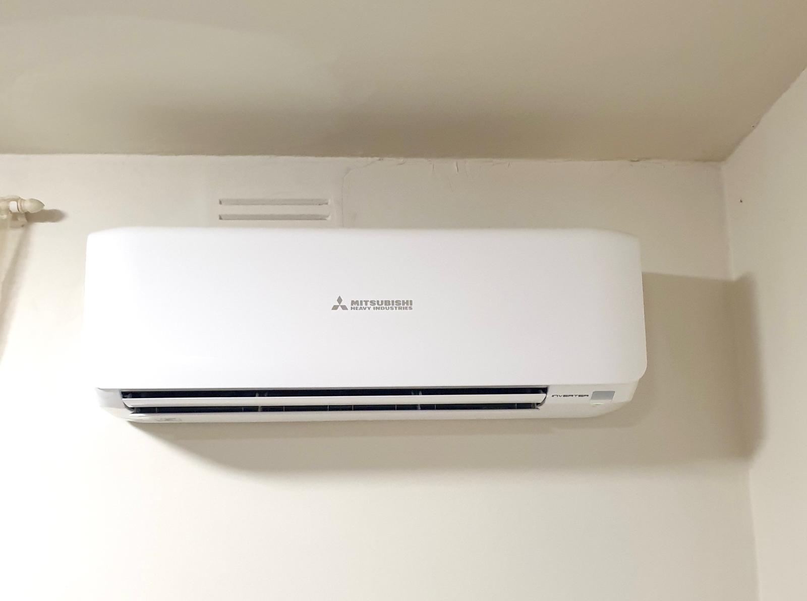 A split system air conditioner mounted on the wall of a Melbourne home, indoor unit above a doorway