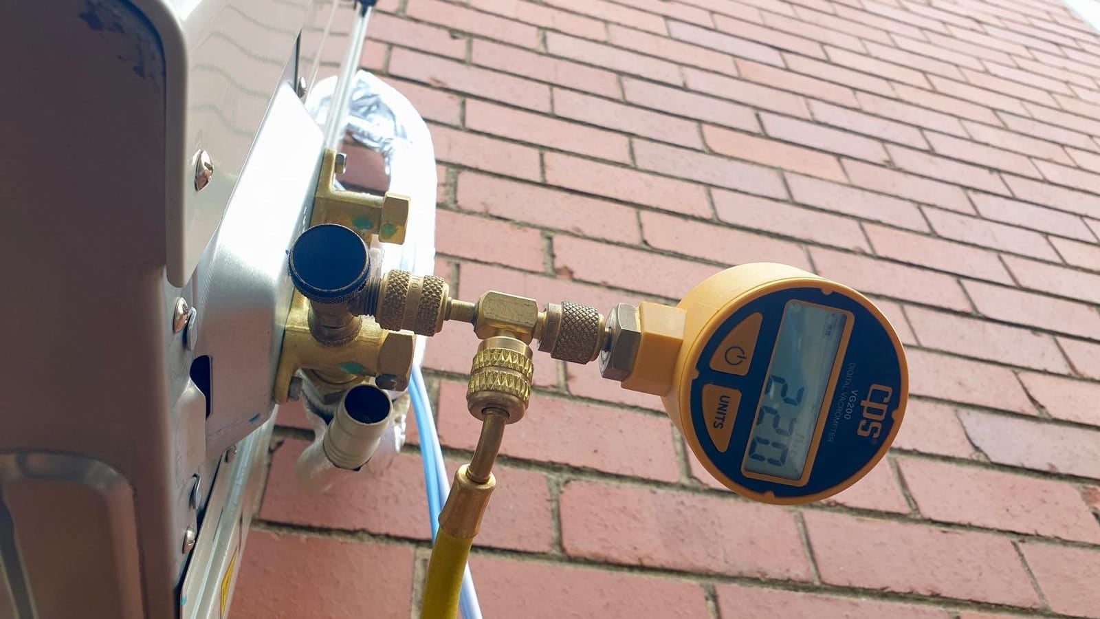 Digital vacuum gauge connected to the service valve of an outdoor unit