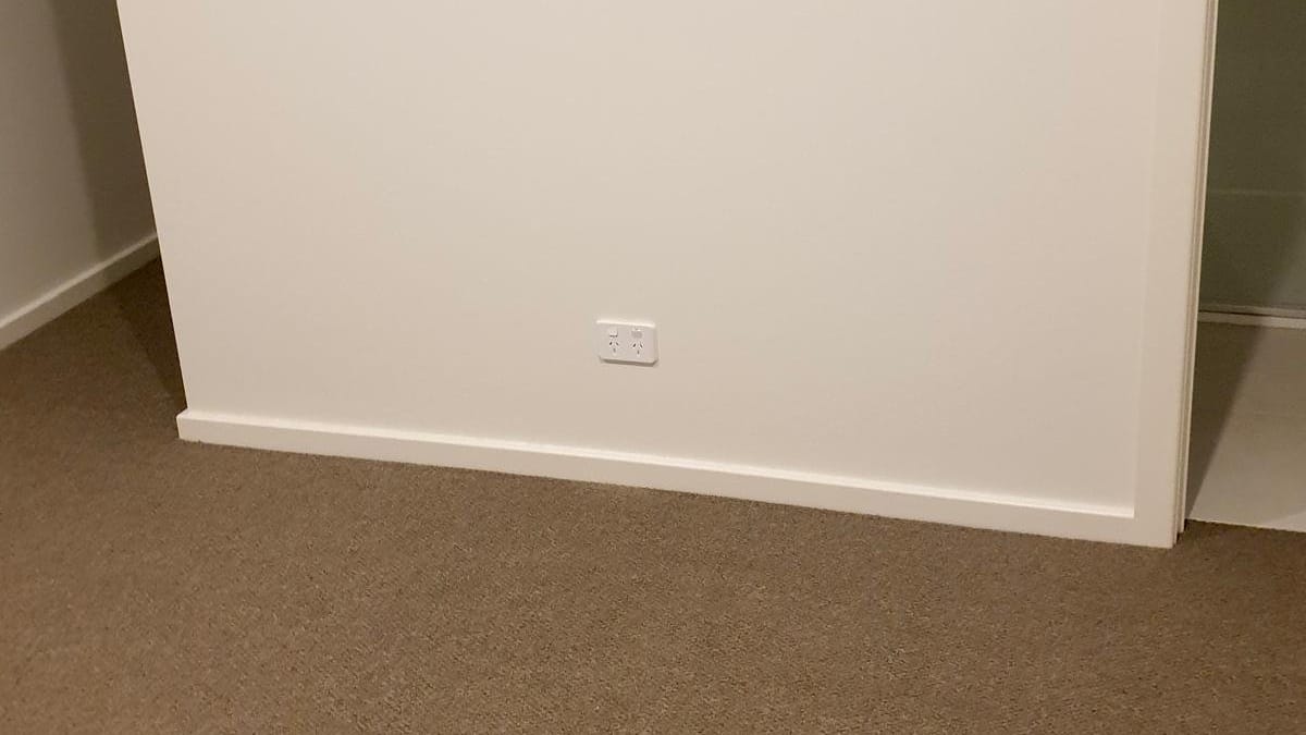 Double power point low on a freshly painted bedroom wall
