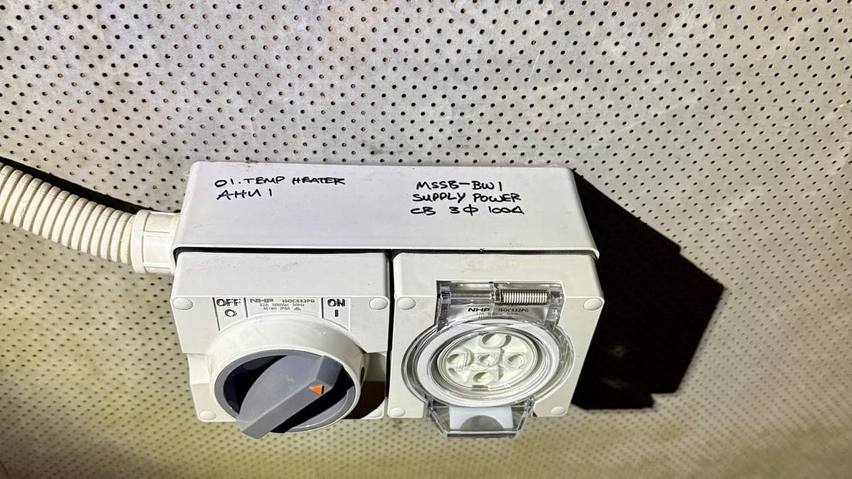 Industrial isolator switch and three-phase power point with handwritten circuit labels