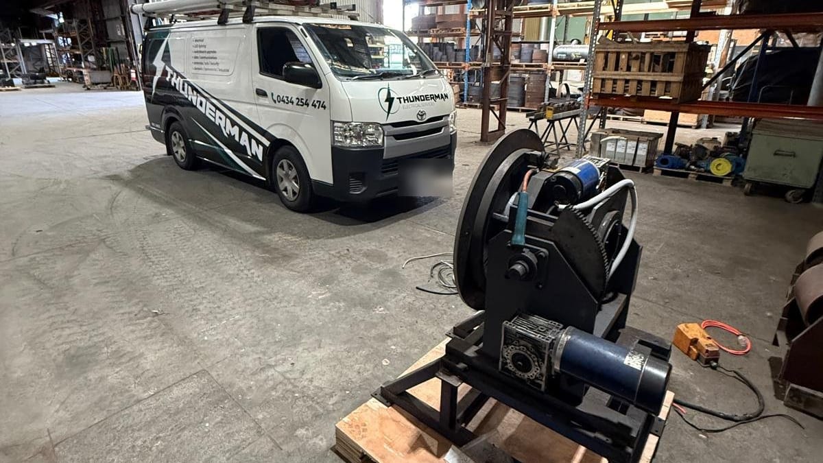 Thunderman van parked in a large industrial shed beside a motor assembly on a pallet