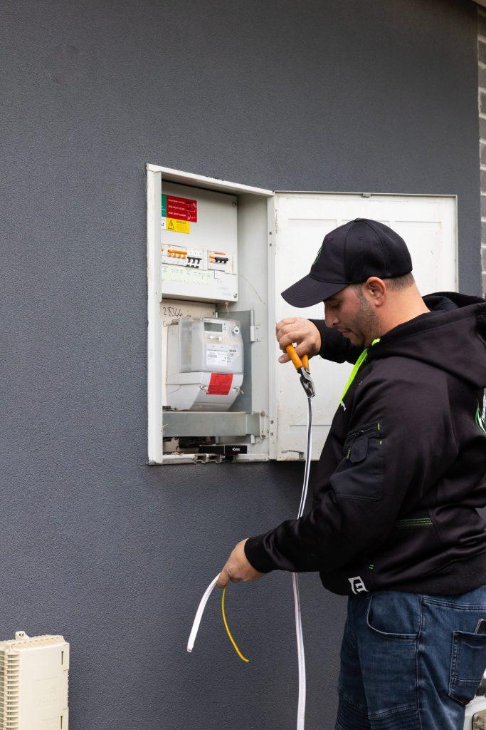 Thunderman electrician working on an outdoor electrical meter box in Melbourne