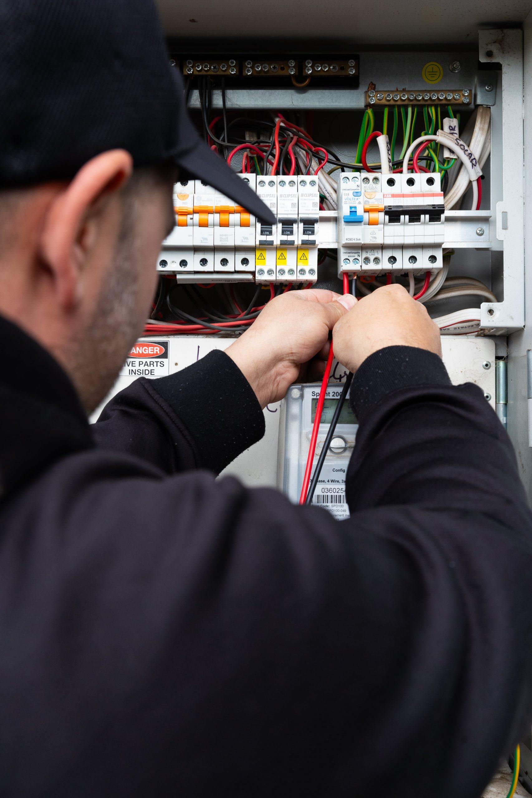 Electrician from Thunderman Electrical Services working on a circuit breaker box